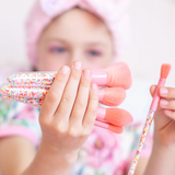 Kids makeup brush set by Oh Flossy featuring colorful, soft brushes with playful sprinkle design for imaginative play.