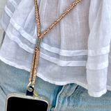 Salty Safari cross body phone strap with diamond-like accents, stylish and functional for carrying phones easily.
