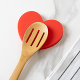 Fisura Heart-shaped spoon rest with a smooth ceramic surface, designed to keep utensils organized and clean.