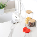 Fisura Heart spoon rest with a smooth, ceramic design, perfect for holding spoons and preventing countertop messes.