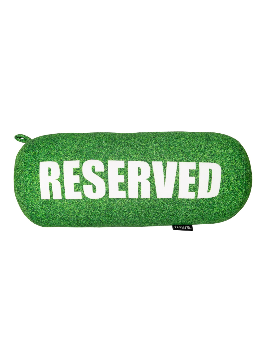 Fisura grass cushion labeled "reserved" with a natural green grassy design, ideal for home decor or outdoor seating.