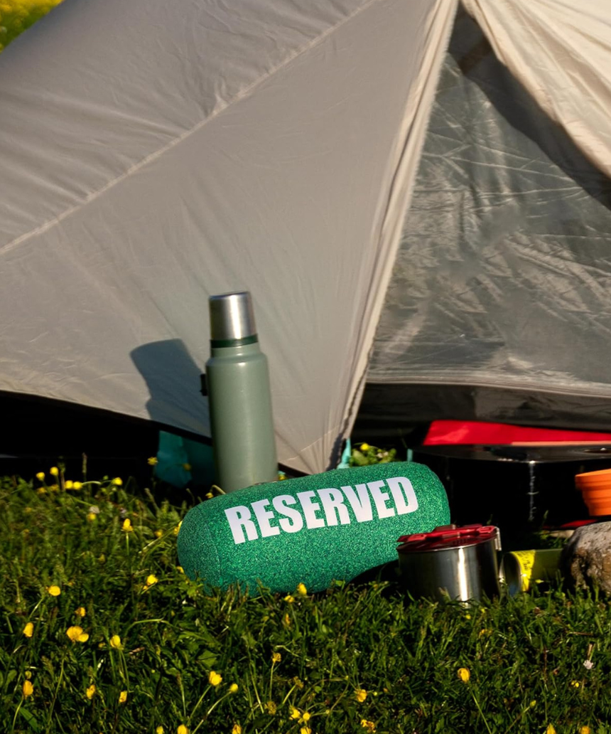 Fisura Grass Cushion labeled "reserved" with green grass design, soft fabric, and plush filling for comfortable seating.