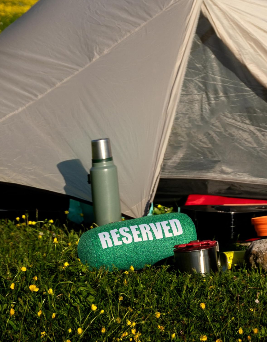 Fisura Grass Cushion labeled "reserved" with green grass design, soft fabric, and plush filling for comfortable seating.