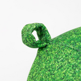 Fisura grass cushion labeled "reserved" with a textured green fabric, designed for comfortable seating or decorative use.