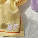 Kip & Co embroidered linen 4-piece breakfast napkin set with colorful "Breakfast Is Served" design and floral embroidery.