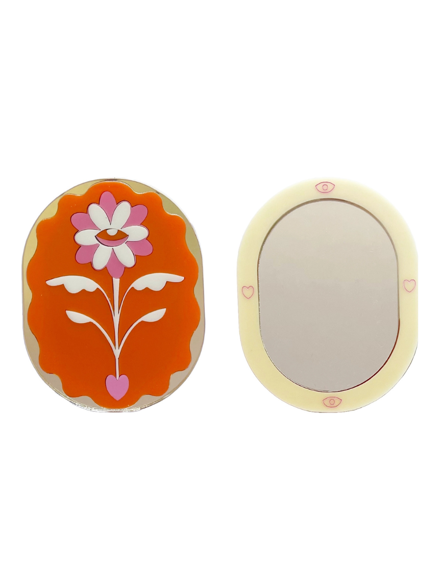 Stof Studios Eden pocket mirror with orange and gold design, compact and stylish accessory for on-the-go reflection.