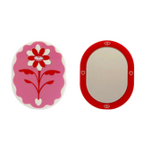 Pink and red Eden pocket mirror by Stof Studios featuring a compact, stylish design with a reflective surface.