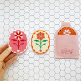 Pink and red Eden pocket mirror by Stof Studios featuring a compact, stylish design with a reflective surface.