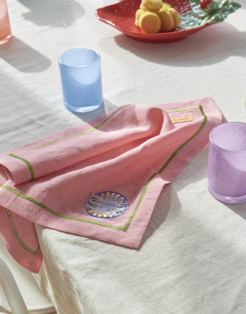 Kip & Co embroidered linen napkin set featuring four stylish napkins with colorful embroidered designs on natural linen fabric.