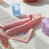 Kip & Co embroidered linen napkin set featuring four stylish napkins with colorful embroidered designs on natural linen fabric.