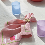 Kip & Co Supper Club embroidered linen napkin set with four colorful, stylish napkins featuring intricate embroidery details.