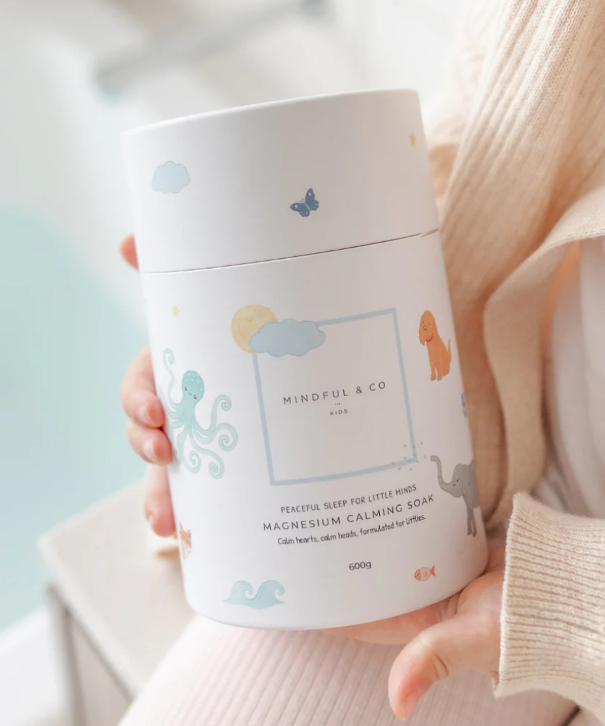 Mindful and Co Kids magnesium calming soak bath additive with calming ingredients, in a clear bottle with label and bath salts.