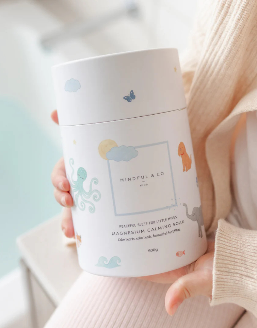 Mindful and Co Kids magnesium calming soak bath additive with calming ingredients, in a clear bottle with label and bath salts.