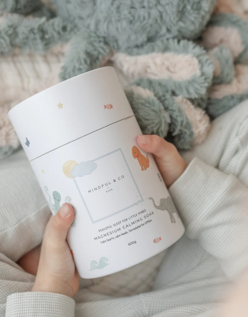 Kids magnesium calming soak bath additive from Mindful and Co Kids, showing a colorful bottle with soothing bath salts inside.