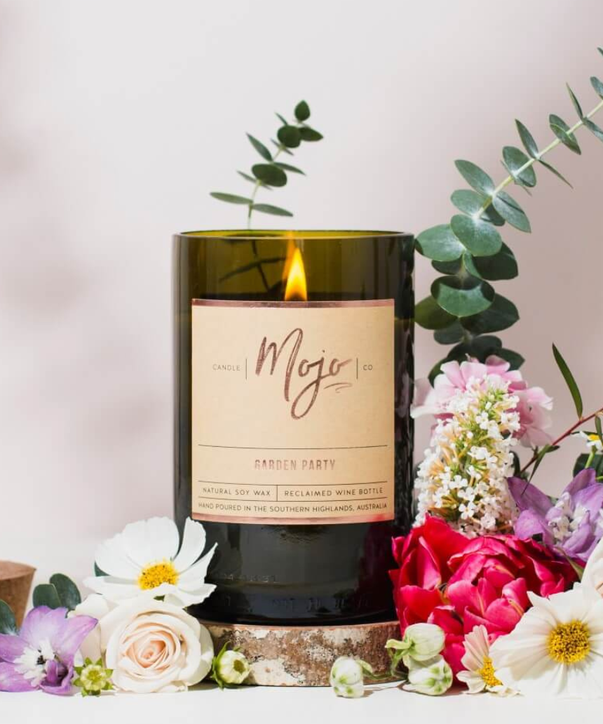 Mojo Candle Co. Garden Party candle with floral design, featuring a glass jar and a white wax interior.
