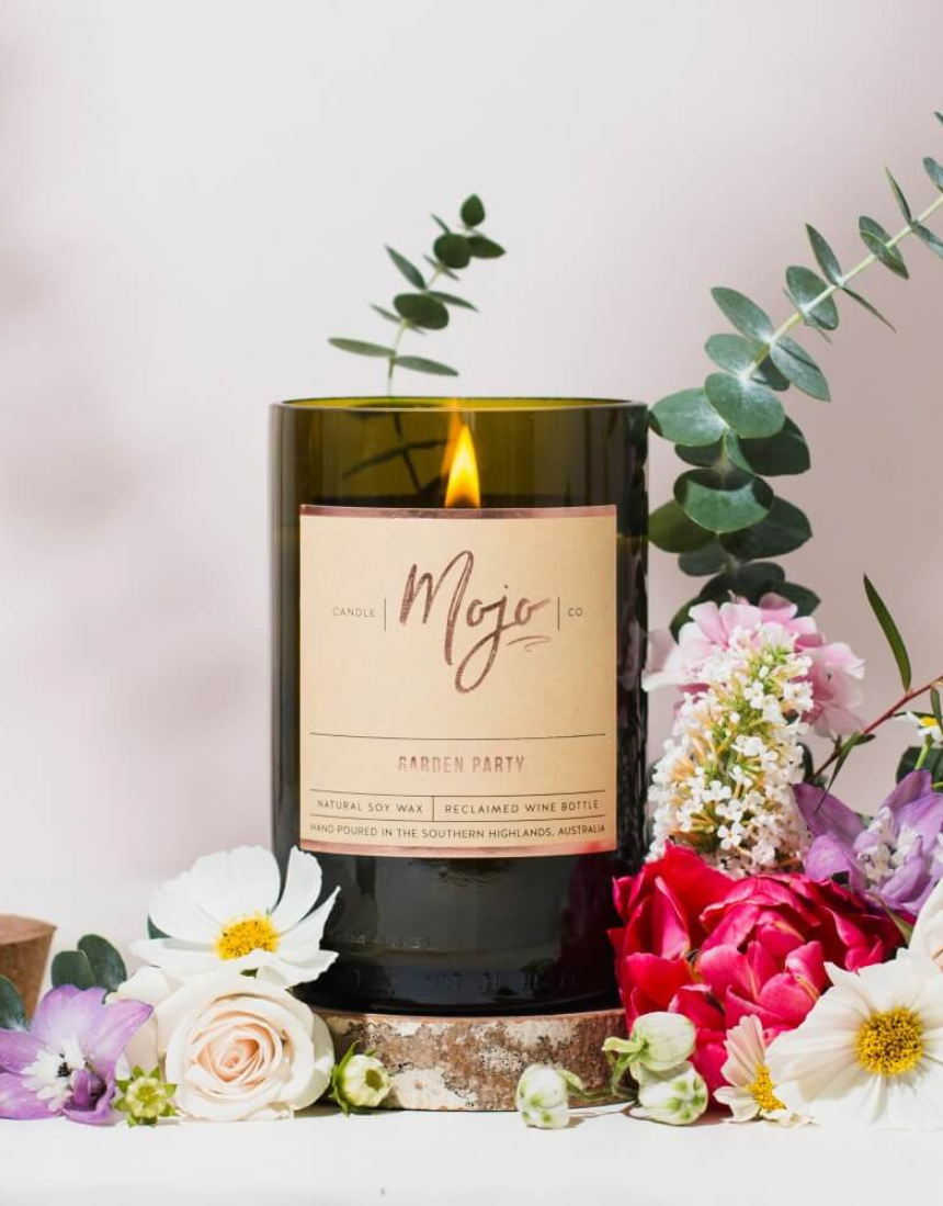 Mojo Candle Co. Garden Party candle with floral design, featuring a glass jar and a white wax interior.