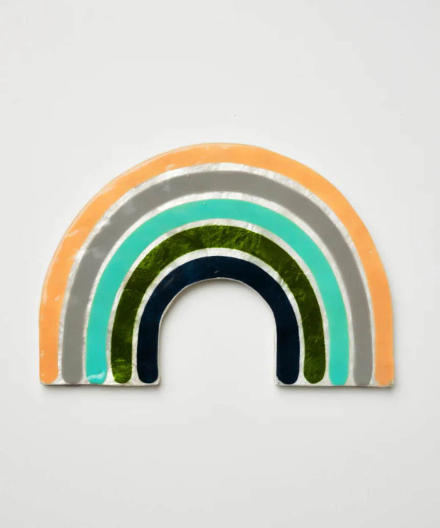 Jones & Co Golden Rainbow Pink wall decor featuring a vibrant rainbow design on a decorative wall hanging.