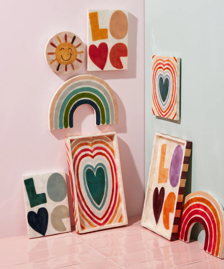 Jones & Co Golden Rainbow Pink wall decor featuring a colorful rainbow design on a neutral background.