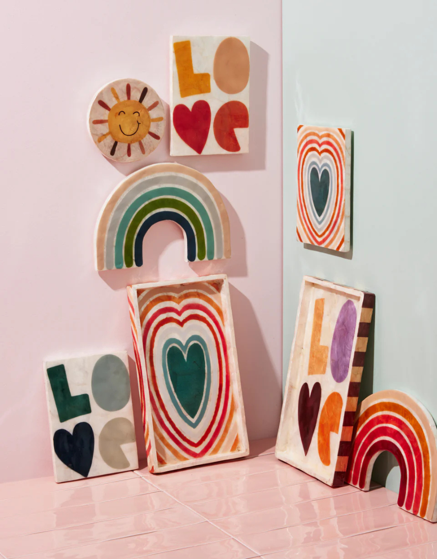 Jones & Co Golden Rainbow Pink wall decor featuring a colorful rainbow design on a neutral background.