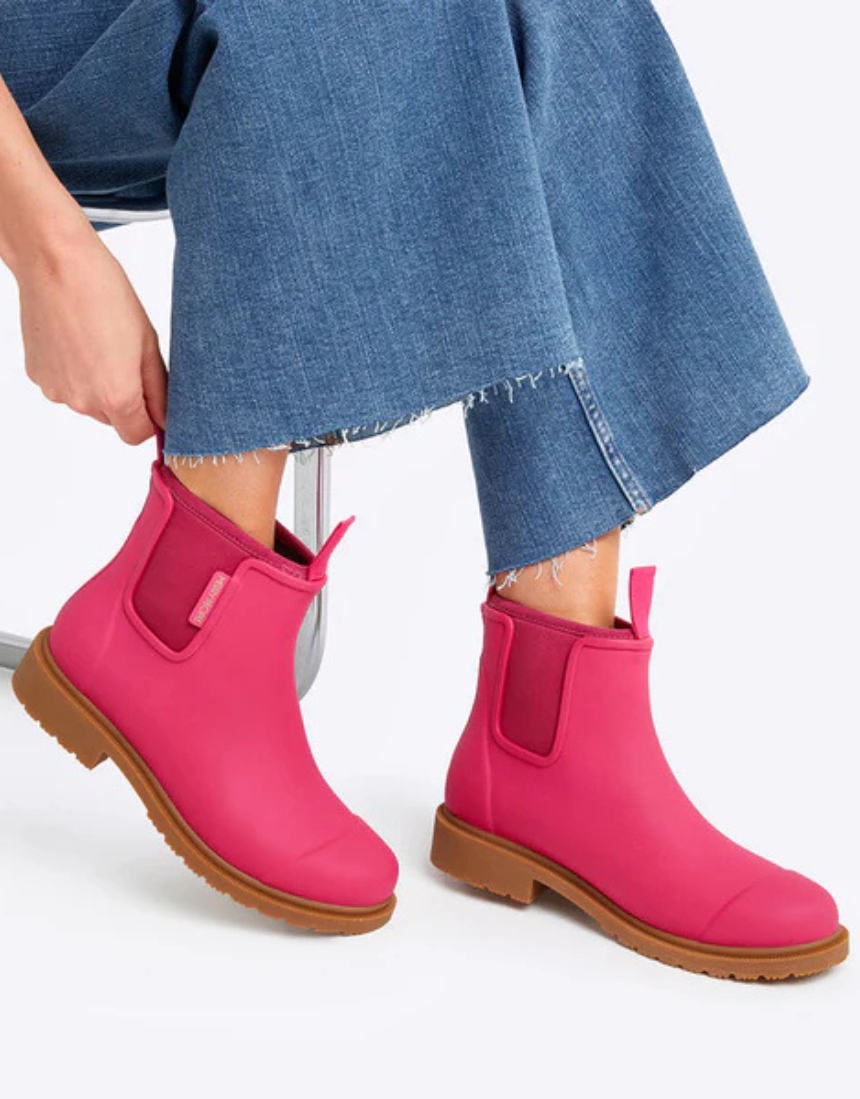 Fuchsia pink Merry People Bobbi gumboots with black soles, stylish rain footwear for women.