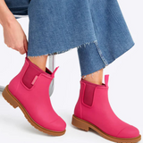 Fuchsia pink Merry People Bobbi gumboots with black soles, stylish rain footwear for women.