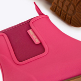 Fuchsia pink Merry People Bobbi gumboots with waterproof rubber and sturdy soles, designed for outdoor wear.
