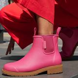 Fuchsia pink Merry People Bobbi gumboots with waterproof design and rubber soles, suitable for rainy weather.