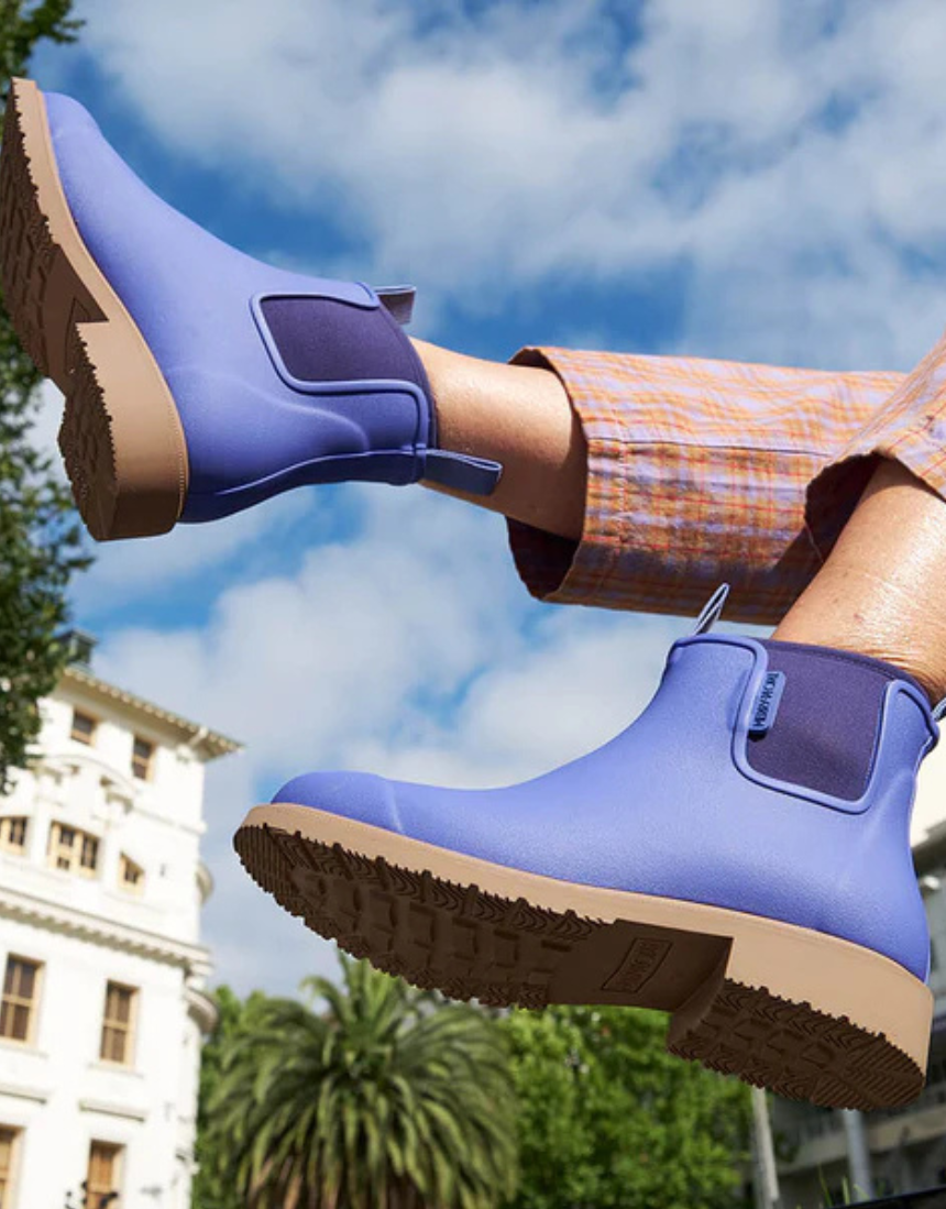 Violet and blue Merry People Bobbi gumboots with floral design, waterproof rubber footwear, on a white background.