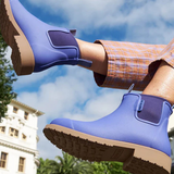 Violet and blue Merry People Bobbi gumboots with floral design, waterproof rubber footwear, on a white background.