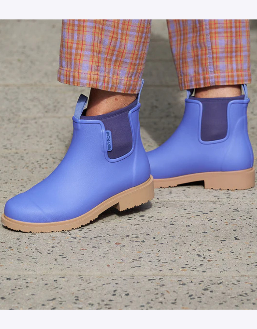 Violet and blue Merry People Bobbi gumboots with floral pattern, waterproof rubber footwear for rainy weather.