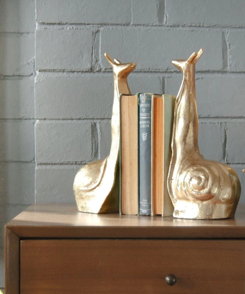 White Moose snail-shaped gold bookends, decorative bookends featuring a whimsical snail design for holding books upright.