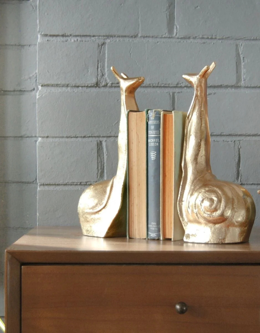 White Moose snail-shaped gold bookends, decorative bookends featuring a whimsical snail design for holding books upright.