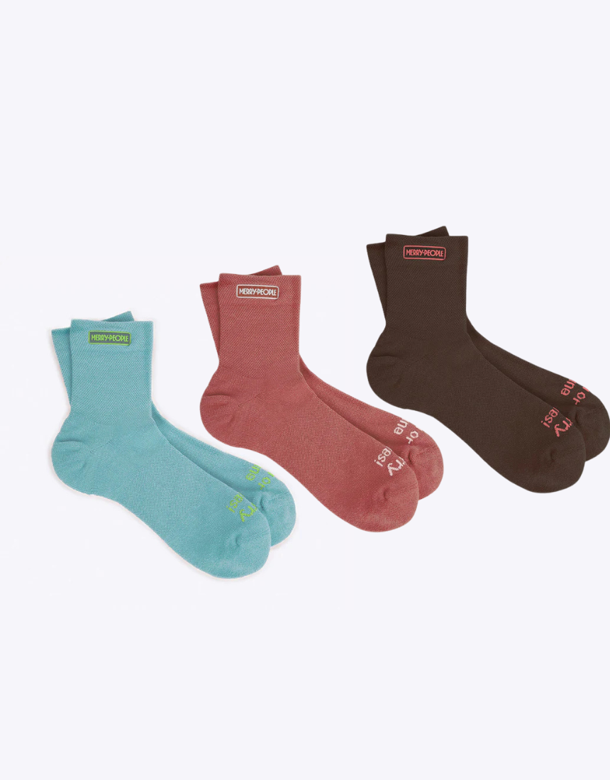 Set of three Merry People socks in colorful patterns, featuring playful designs and cozy knit fabric.