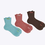 Set of three Merry People socks in colorful patterns, featuring playful designs and cozy knit fabric.