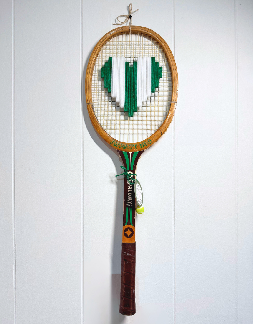 What A Racquet! green and white heart-shaped tennis racquet with a decorative handle design.