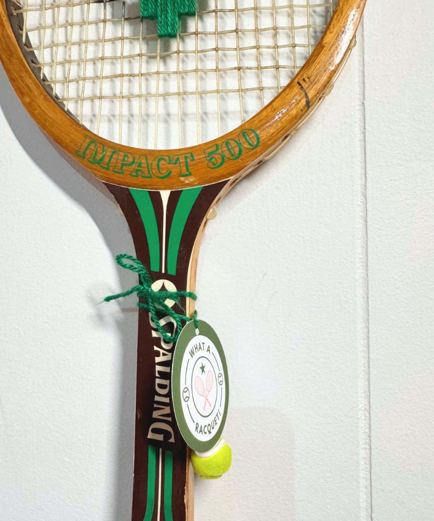 Green and white heart-shaped tennis racquet from What A Racquet! with a vibrant design and ergonomic grip.