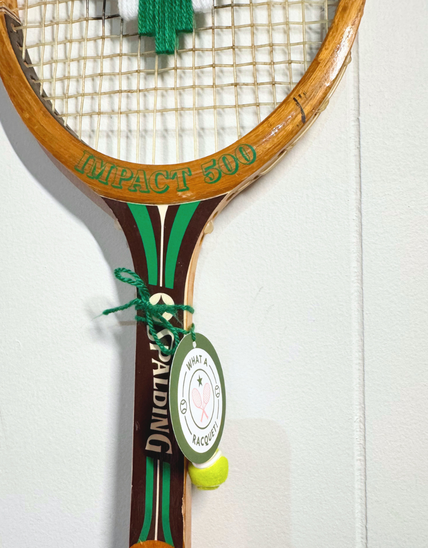 Green and white heart-shaped tennis racquet from What A Racquet! with a vibrant design and ergonomic grip.