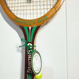 Green and white heart-shaped tennis racquet from What A Racquet! with a vibrant design and ergonomic grip.
