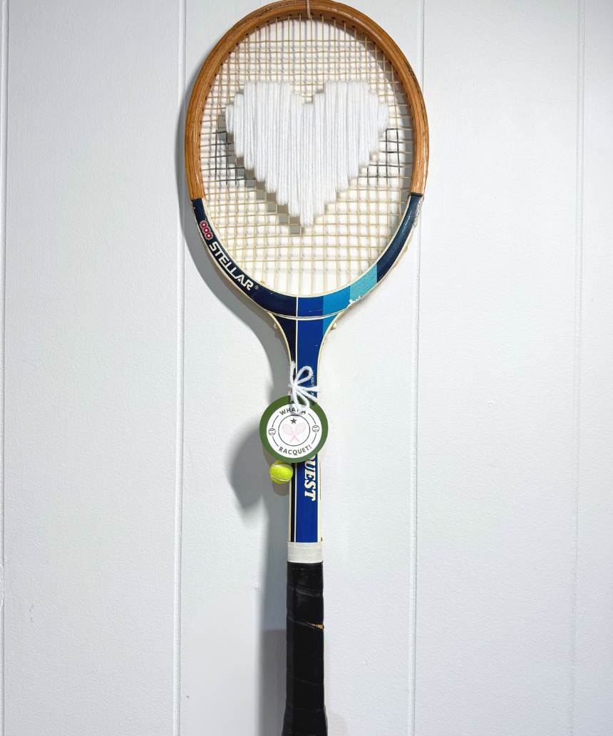 White heart-shaped tennis racquet from What A Racquet! with a sleek design and comfortable grip.