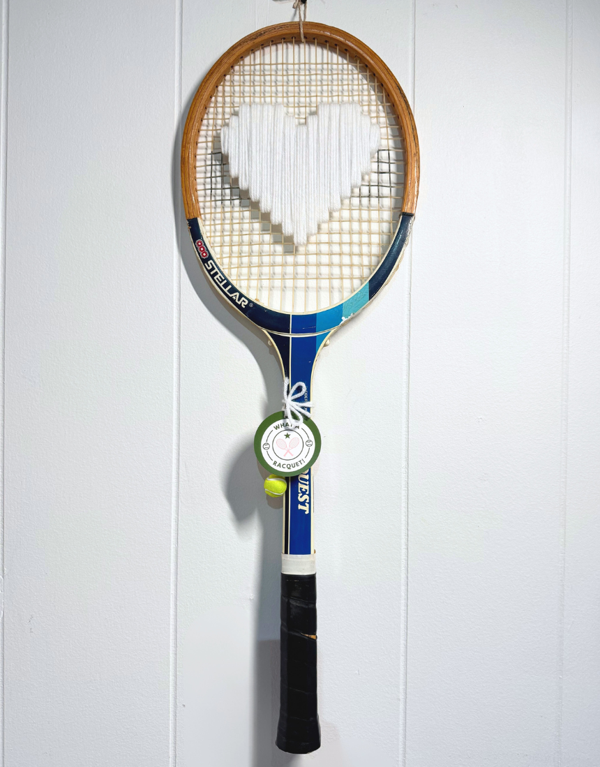 White heart-shaped tennis racquet from What A Racquet! with a sleek design and comfortable grip.