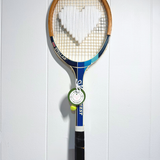 White heart-shaped tennis racquet from What A Racquet! with a sleek design and comfortable grip.