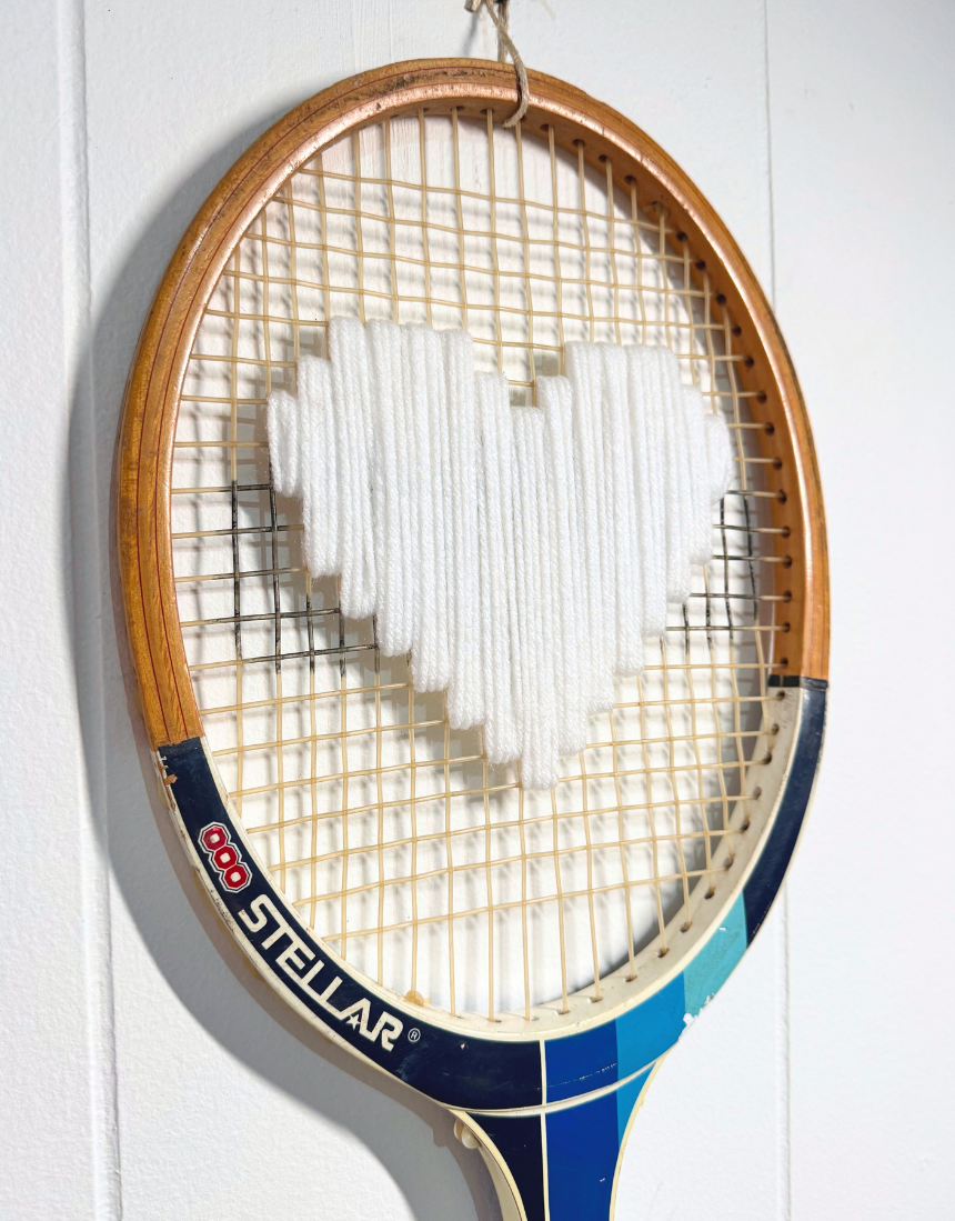 White heart-shaped accessory from What A Racquet! with a stylish, playful design perfect for fashion or gift use.