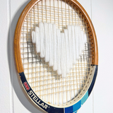 White heart-shaped accessory from What A Racquet! with a stylish, playful design perfect for fashion or gift use.