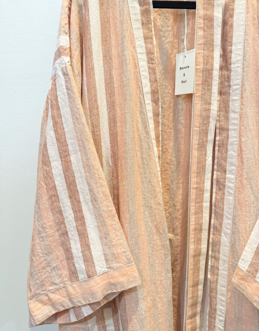 Hazelnut striped robe by Bonnie and Neil, featuring soft fabric and cozy design, displayed on a hanger against a neutral background.