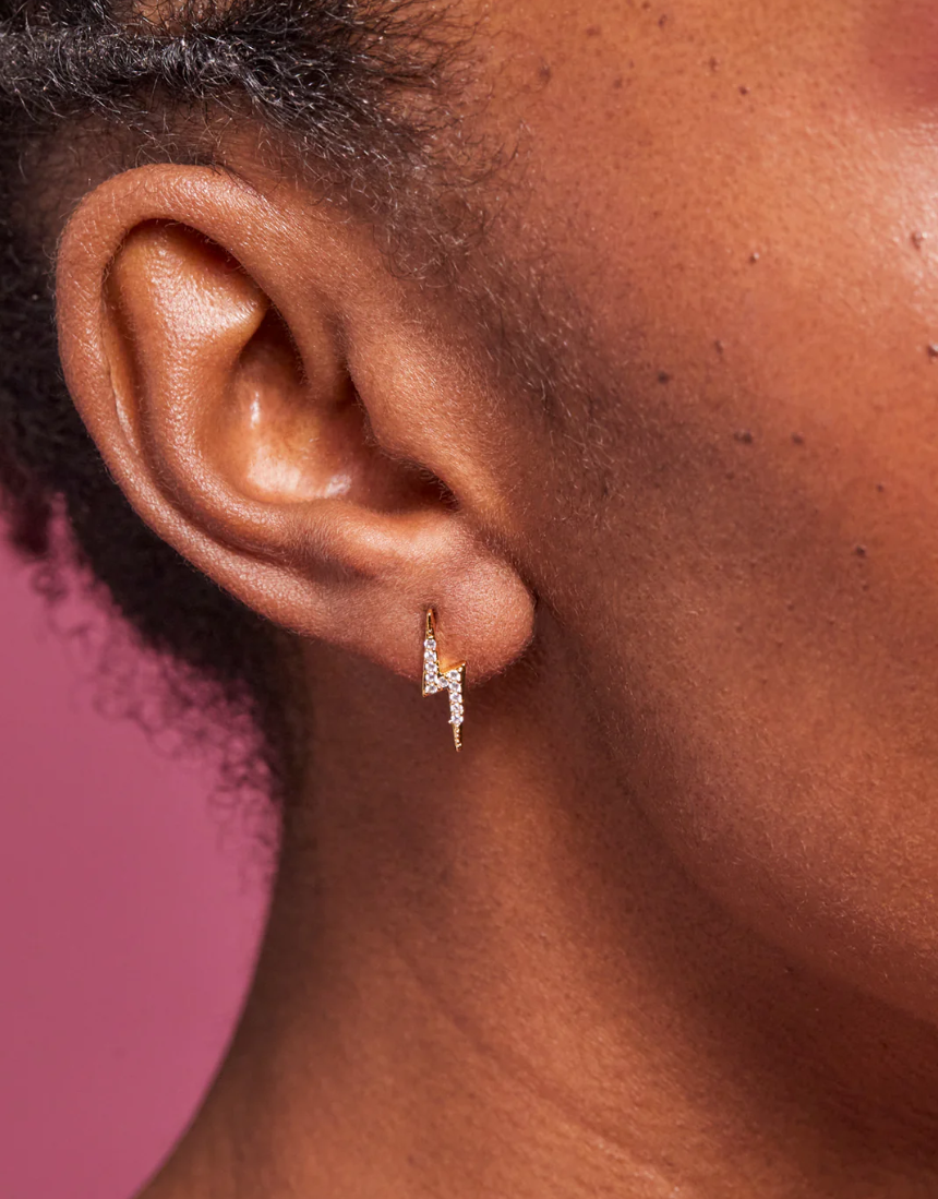 Estella Bartlett lightning bolt earrings with gold-tone finish, featuring sleek, modern lightning bolt design on shiny metal studs.