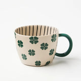 Jones & Co Chino Mug with "Lucky Me" print, featuring a ceramic mug with a cheerful design and bright colors.