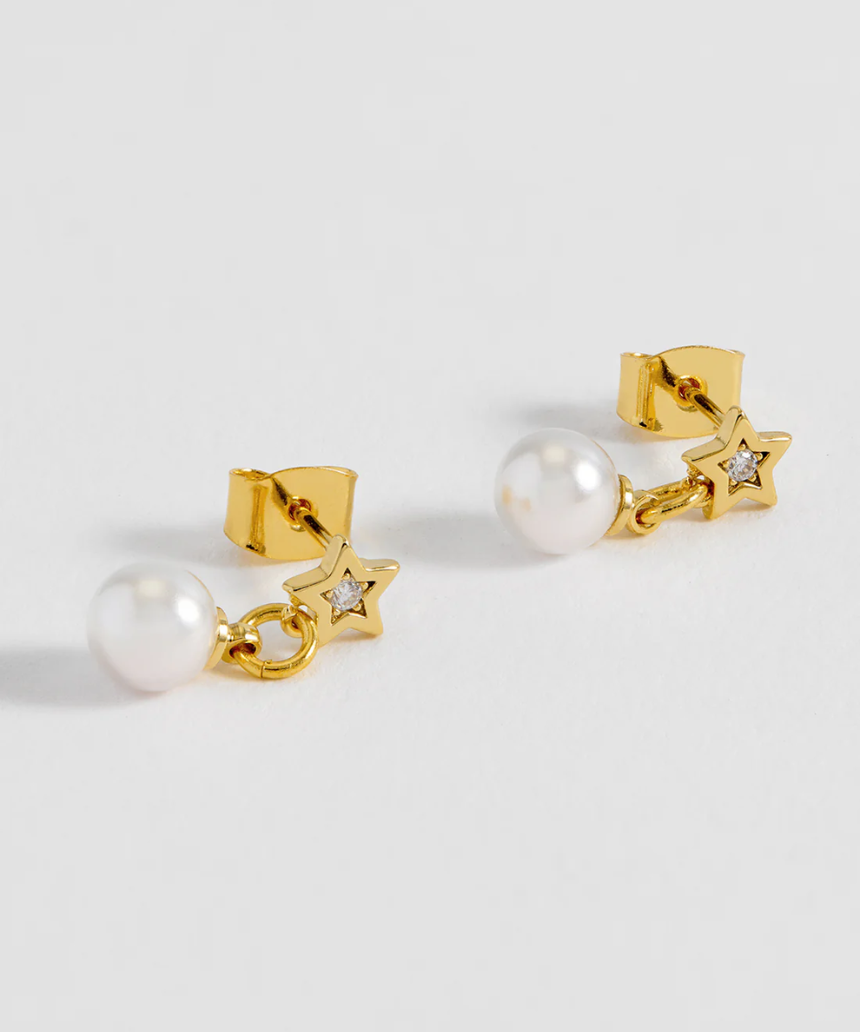 Estella Bartlett star and pearl stud earrings showing silver stars and white pearls on a white background.