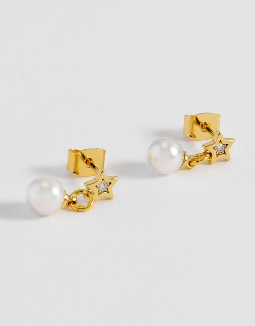 Estella Bartlett star and pearl stud earrings showing silver stars and white pearls on a white background.