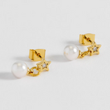 Estella Bartlett star and pearl stud earrings showing silver stars and white pearls on a white background.