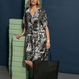 Elk Lento Dress, stylish women’s clothing with flowy fabric and relaxed fit, shown on a model in a natural outdoor setting.